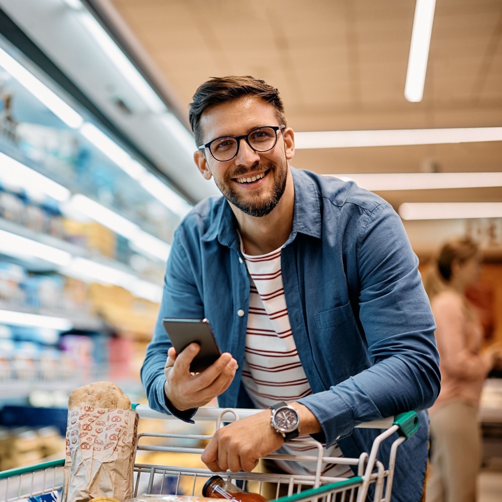 Gig worker checking the Hetal Retail app while shopping
